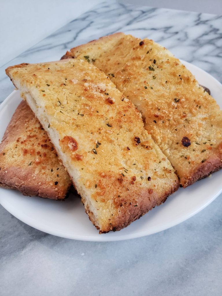 Two ingredient dough garlic bread, a healthy copycat recipe of little Caesar's crazy bread. A low calorie recipe to pair with your low carb meals.